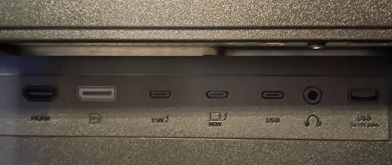 A panel with HDMI, DisplayPort, multiple USB-C, headphone, and USB ports labeled with power specifications and symbols.