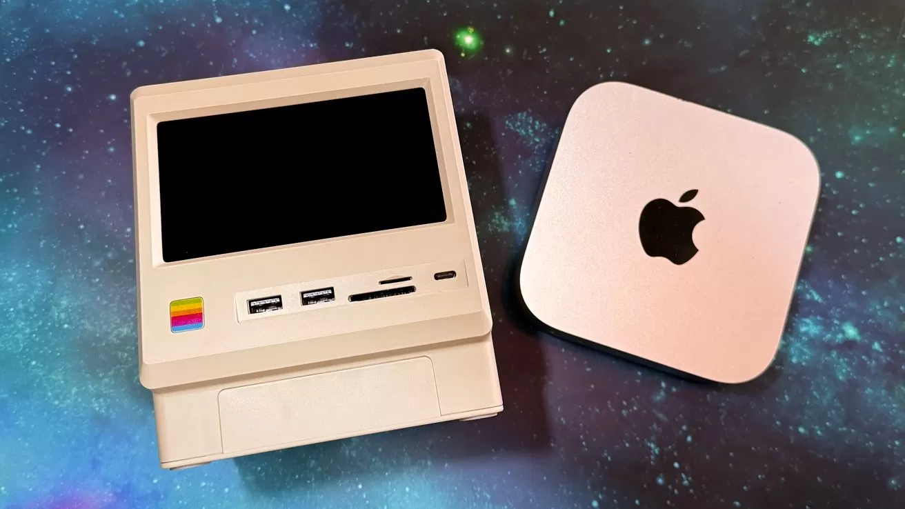 Small retro-style computer with various ports next to a compact square device with an apple logo, set on a galaxy-patterned background.