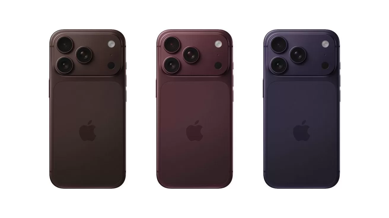Three modern smartphones shown from the back in dark brown, burgundy, and deep navy colors, each with two large camera lenses in the upper left corner and Apple logo centered