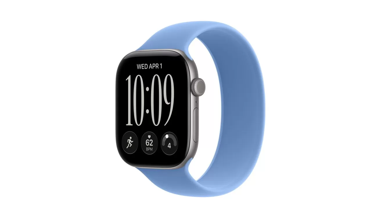 Smartwatch with rectangular black screen, silver edges, and light blue sport band, showing digital time 10:09, date Wednesday April 1, and small circular fitness and activity icons