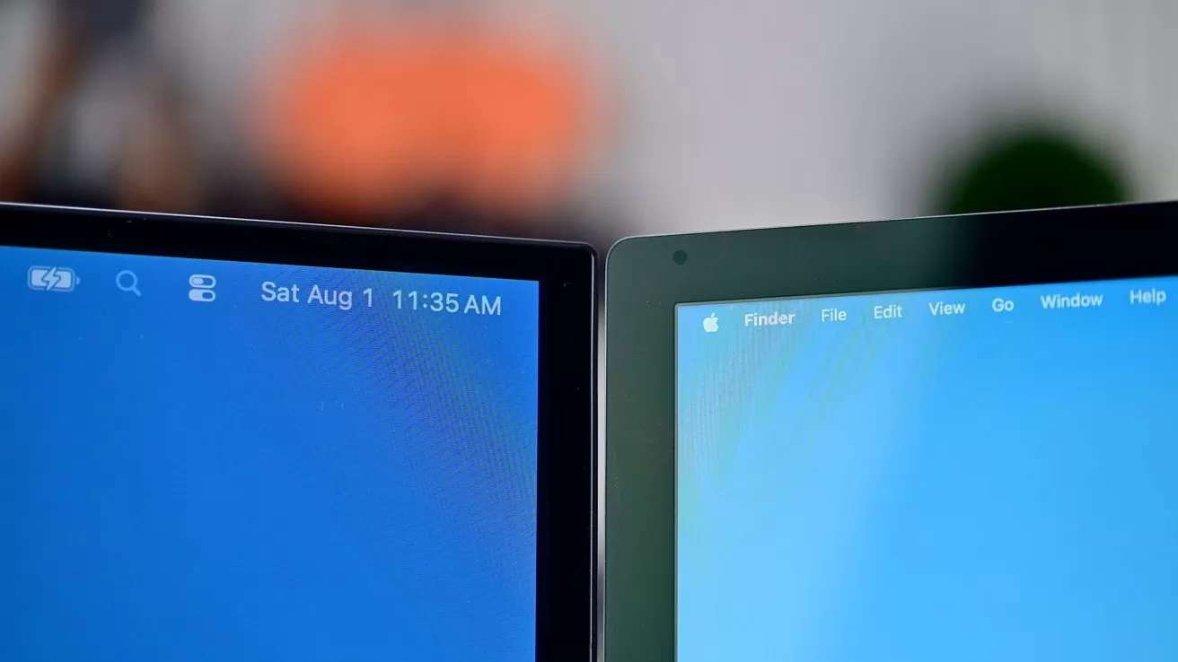 Two laptop screens side by side, each showing a blue desktop with macOS menu bars at the top, one displaying the date and time, with a blurred background behind them