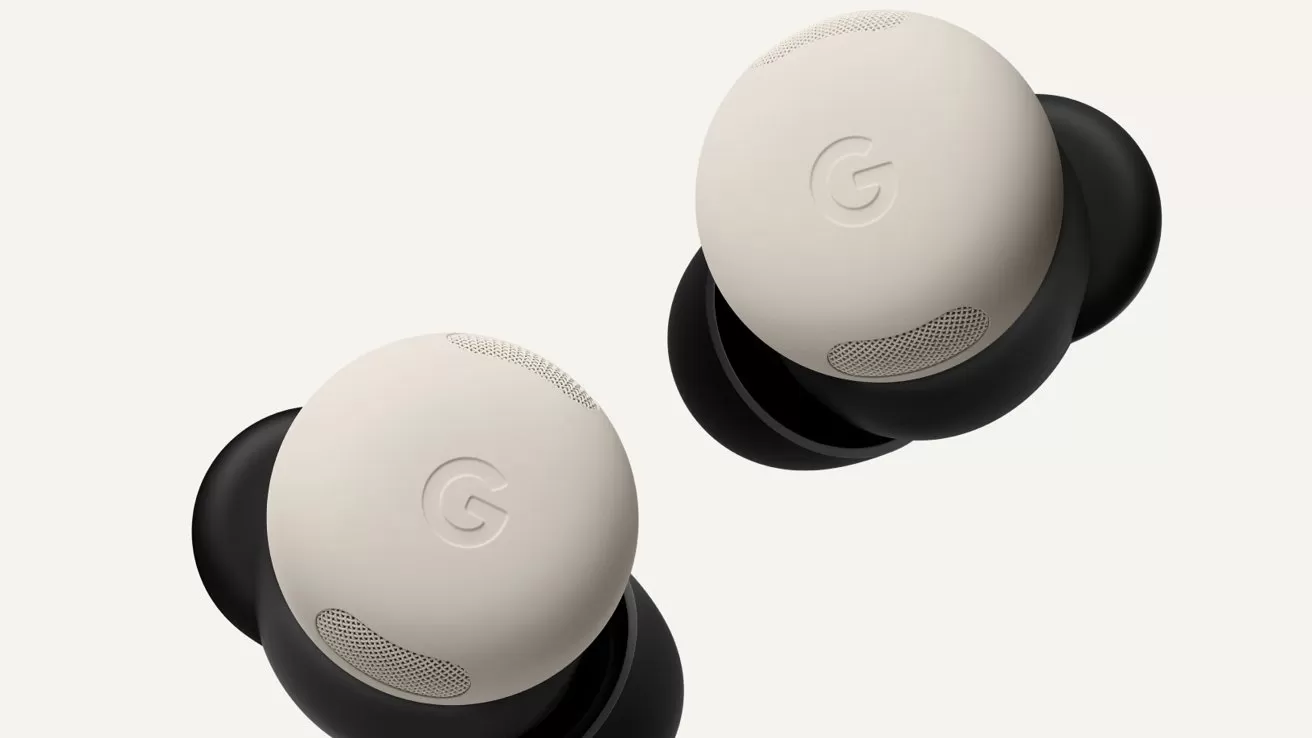 Two beige Google wireless earbuds with black bases floating on a light background, showing the subtle G logo and small speaker grilles on each earbud