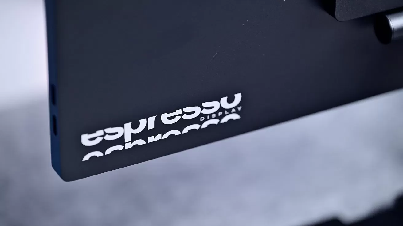 Close-up of a black monitor with the words espresso Display in white, partially visible.