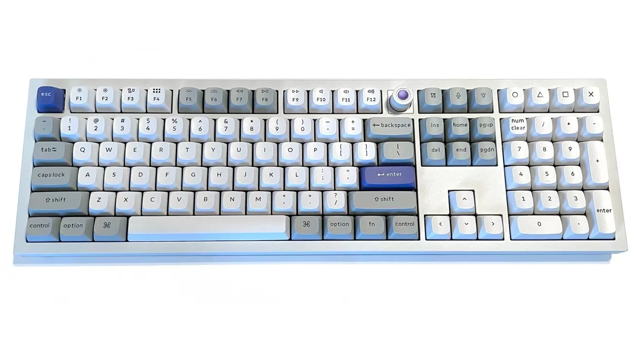 Full-size mechanical keyboard with white and light gray keys, accented by a few dark blue keys, including Enter and spacebar, on a clean white background