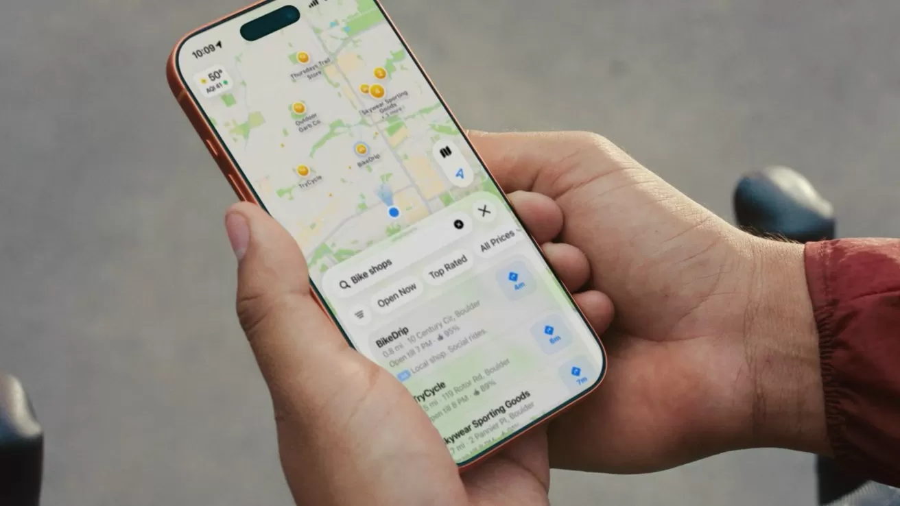 Person holding a smartphone outdoors, using a maps app showing streets, locations, and nearby places, with both hands visible and the screen clearly displaying navigation details
