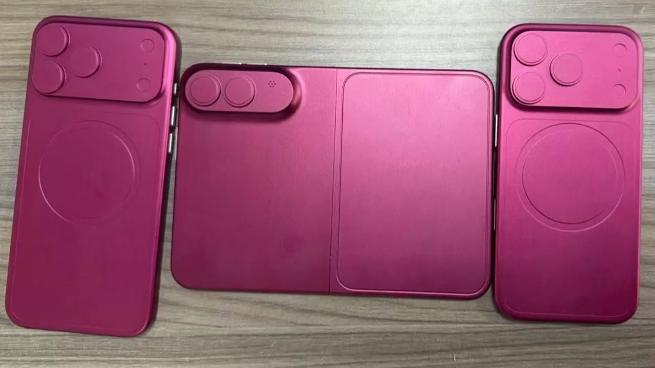 Four magenta phone cases and a matching folding MagSafe-style charging pad laid flat on a wood-grain surface, each case featuring raised circular outlines for camera and charger areas