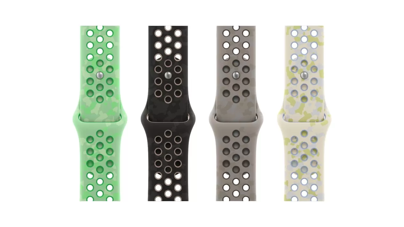Four sporty smartwatch bands in green, black, gray, and cream with circular ventilation holes, shown vertically side by side against a plain white background
