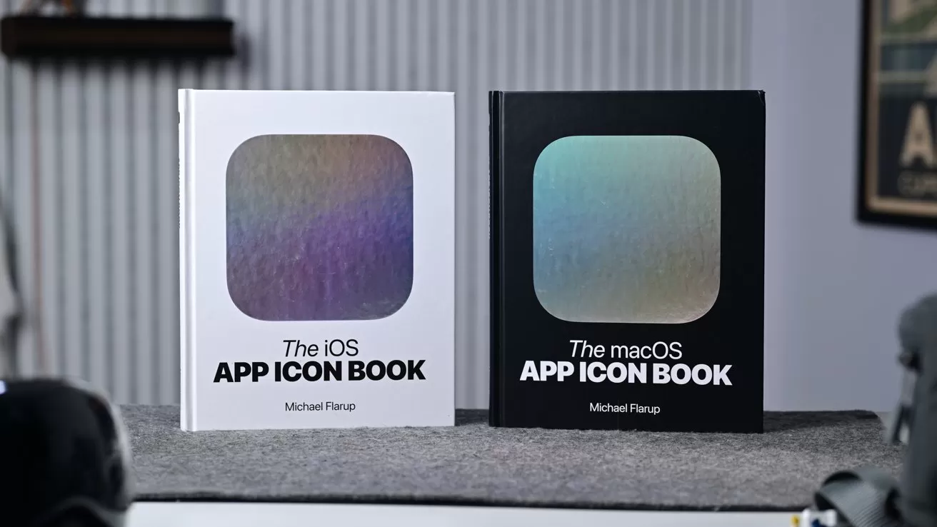 Two hardcover books titled The iOS App Icon Book and The macOS App Icon Book stand upright on a table, each featuring a large iridescent rounded-square icon on the cover
