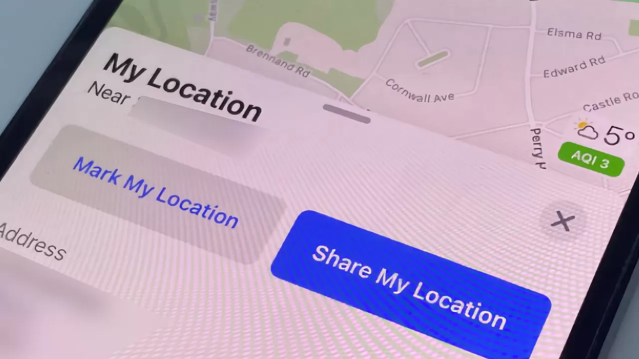 Smartphone screen displaying a map app focused on My Location, with prominent buttons labeled Mark My Location and Share My Location, plus nearby streets and small weather and air quality widgets