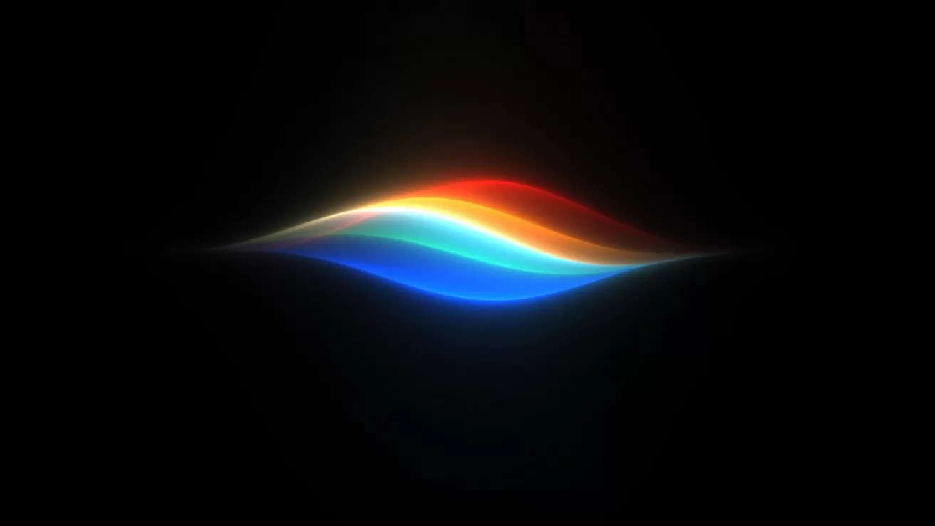 Glowing multicolored wave of light, with red, orange, green, and blue bands, floating on a black background, resembling a stylized sound or voice assistant visualization