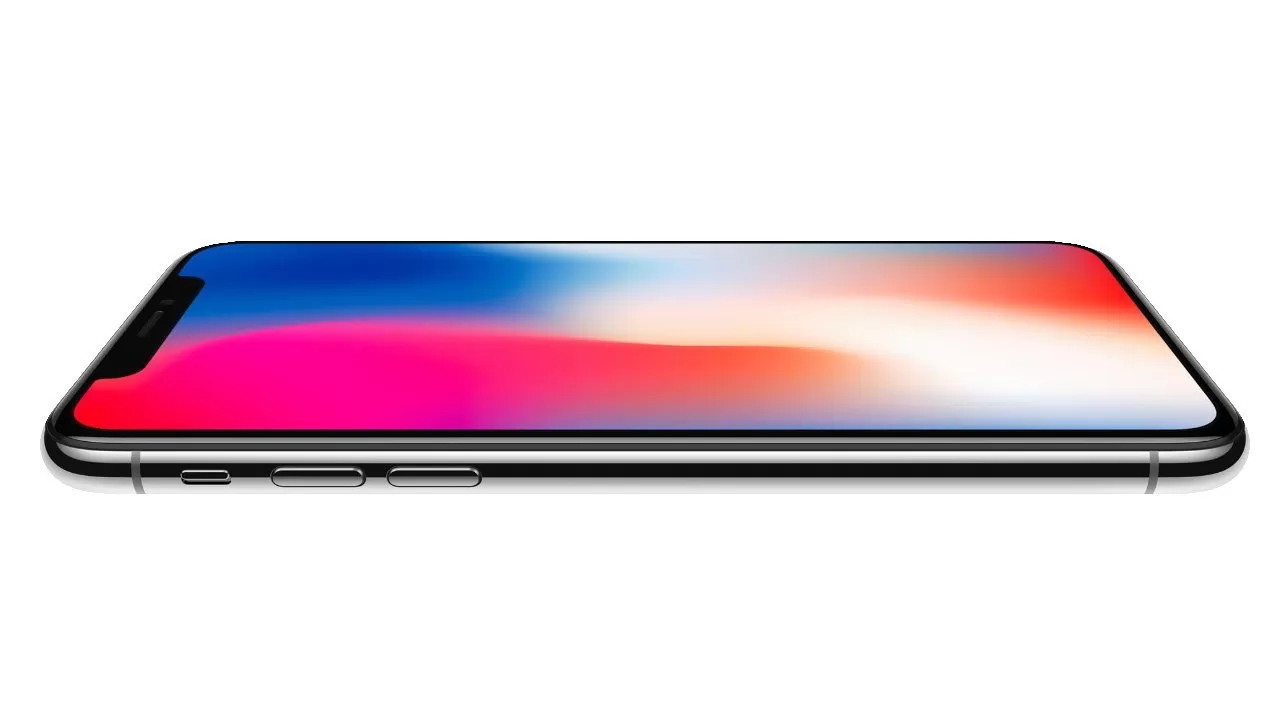 Modern smartphone lying horizontally, screen on, showing a colorful gradient from blue to pink and white, with a thin black bezel and metallic edges against a plain white background