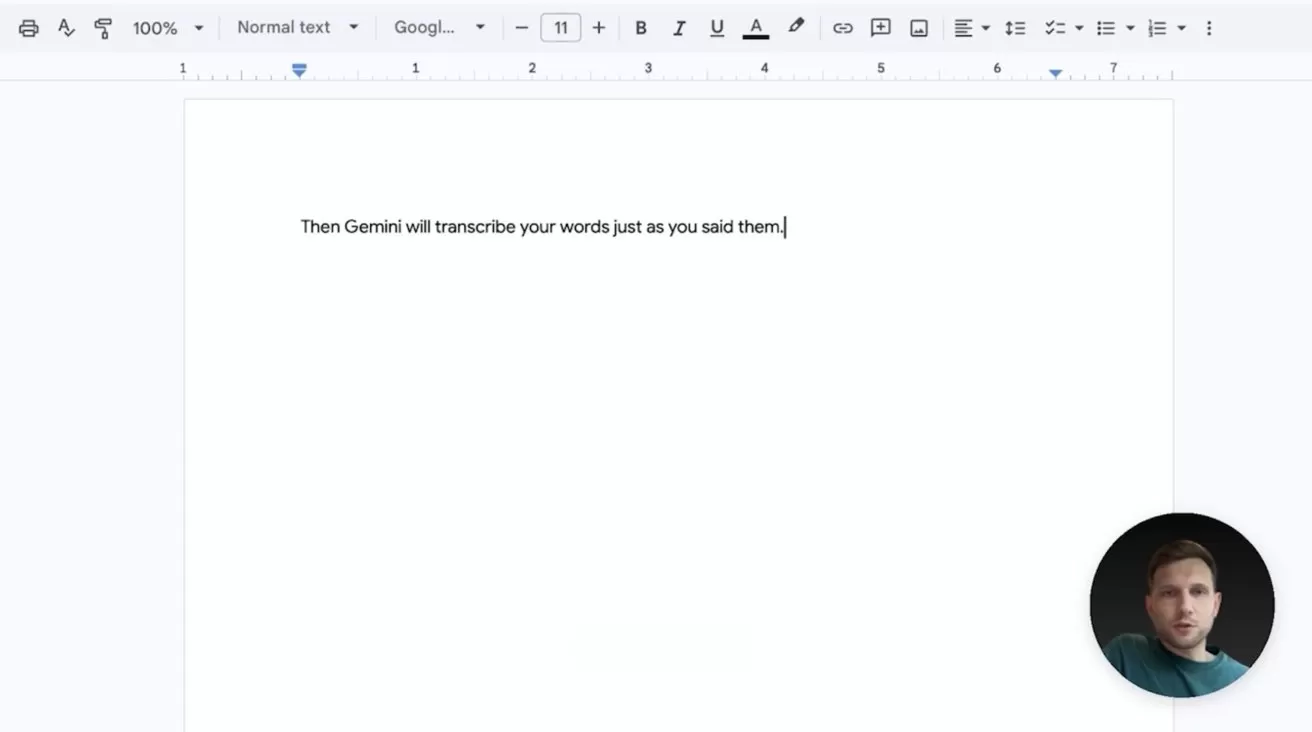 Computer screen showing a Google Docs page with a single typed sentence on a blank document, and a small circular video call window in the bottom right showing a man's face